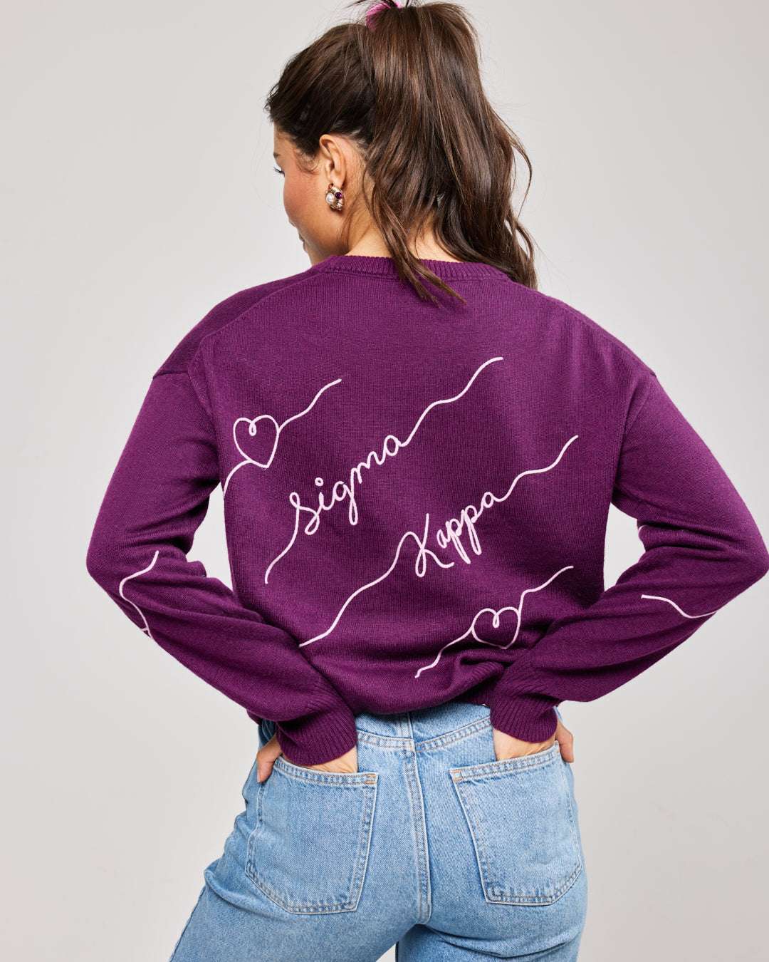 purple and pink crewneck sorority sweater with Sigma Kappa embroidered logo, perfect for dorm move in day