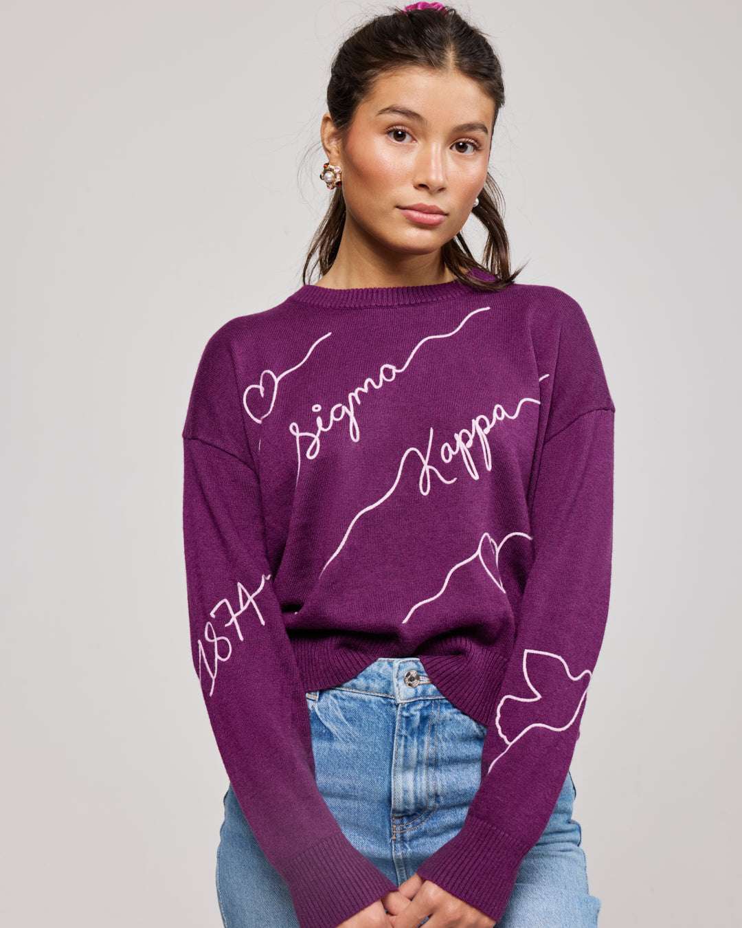 purple and pink crewneck sorority sweater with Sigma Kappa embroidered logo, perfect for dorm move in day