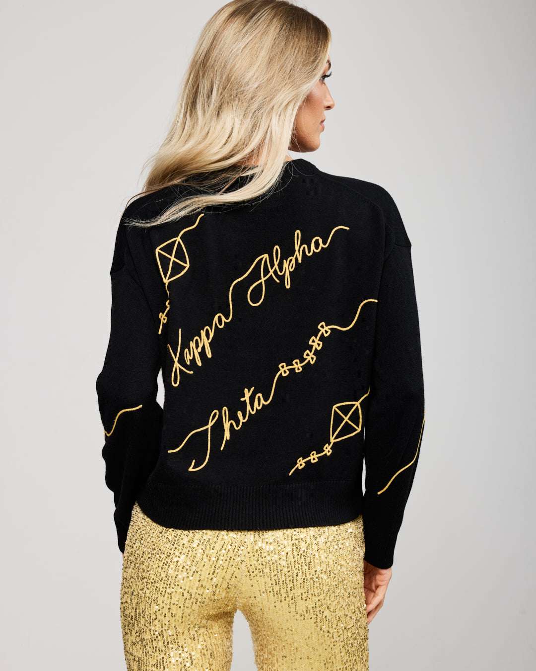 black and gold long sleeve sorority sweater with Kappa Alpha Theta embroidered logo, perfect for sorority sisterhood events