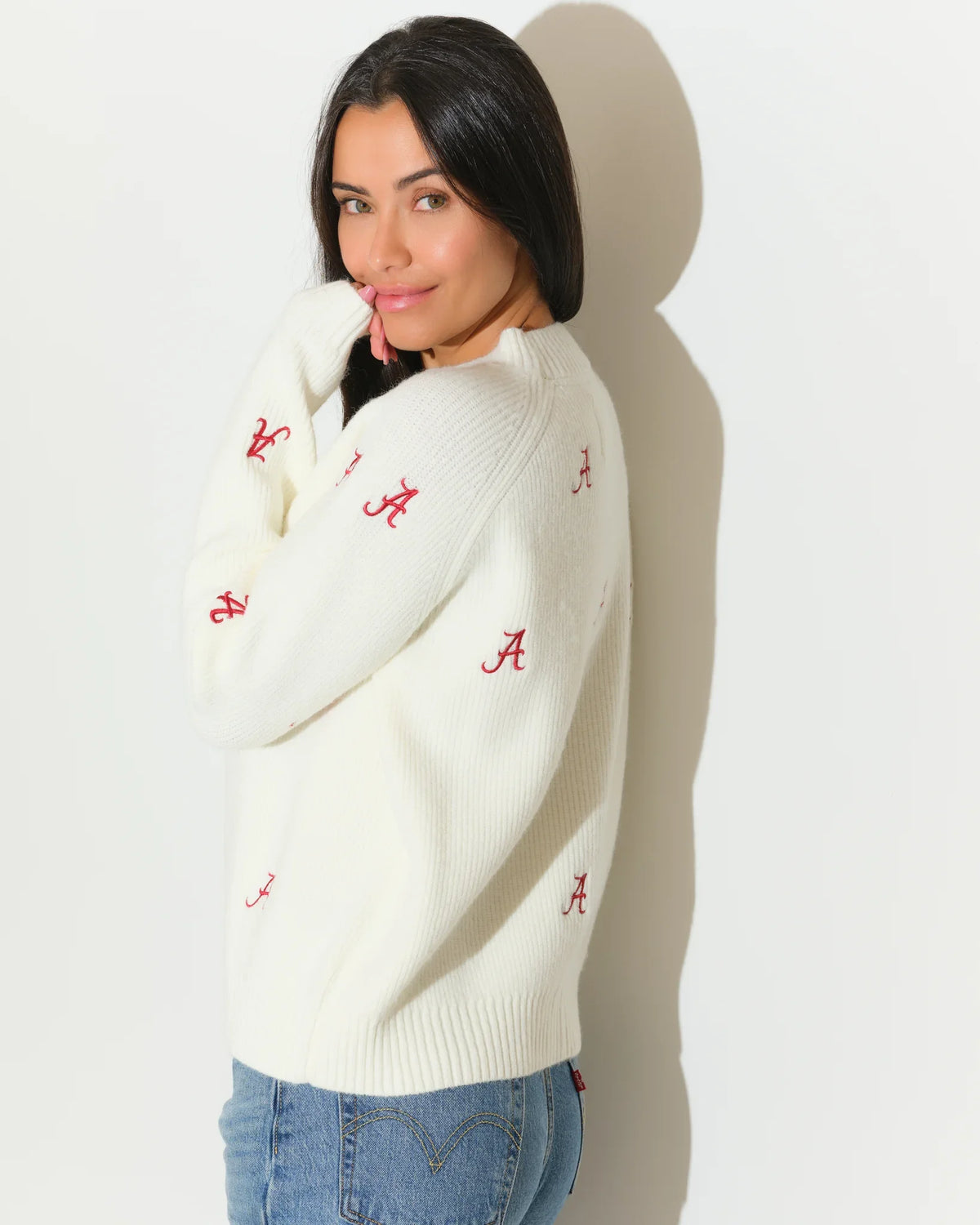 Ivory Alabama Crimson Tide fisherman sweater featuring an allover red "A" logo pattern, shown with a relaxed crewneck fit.