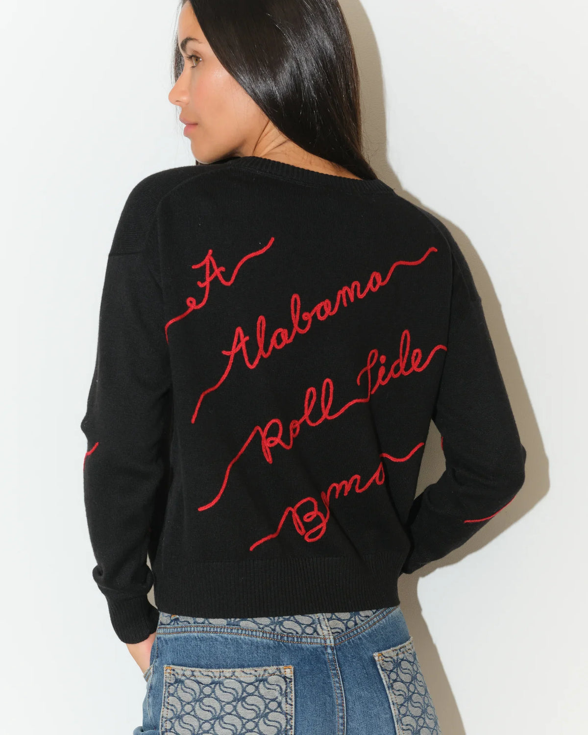 Black Alabama Crimson Tide Love Letter Sweater with red cursive script reading "Alabama," "Roll Tide," and "Bama" across the front and sleeves.