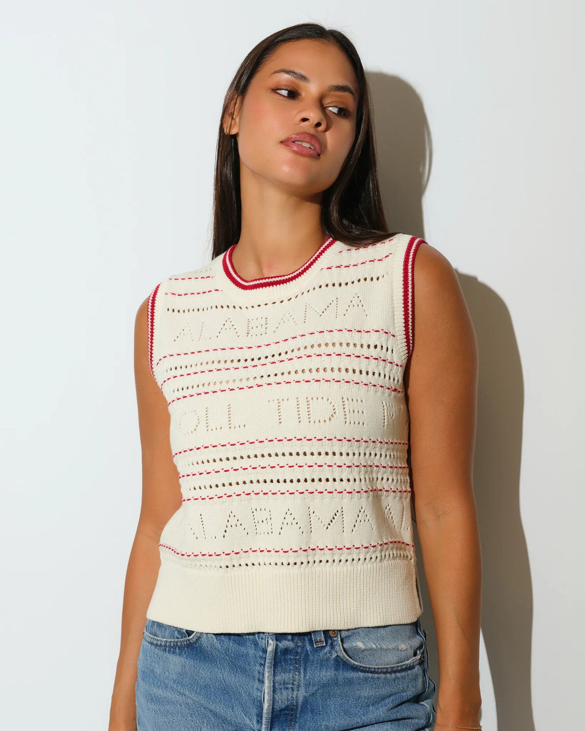 Ivory Alabama Crimson Tide sweater vest with open-knit detailing, embroidered team lettering, and red trim at the neckline and armholes.