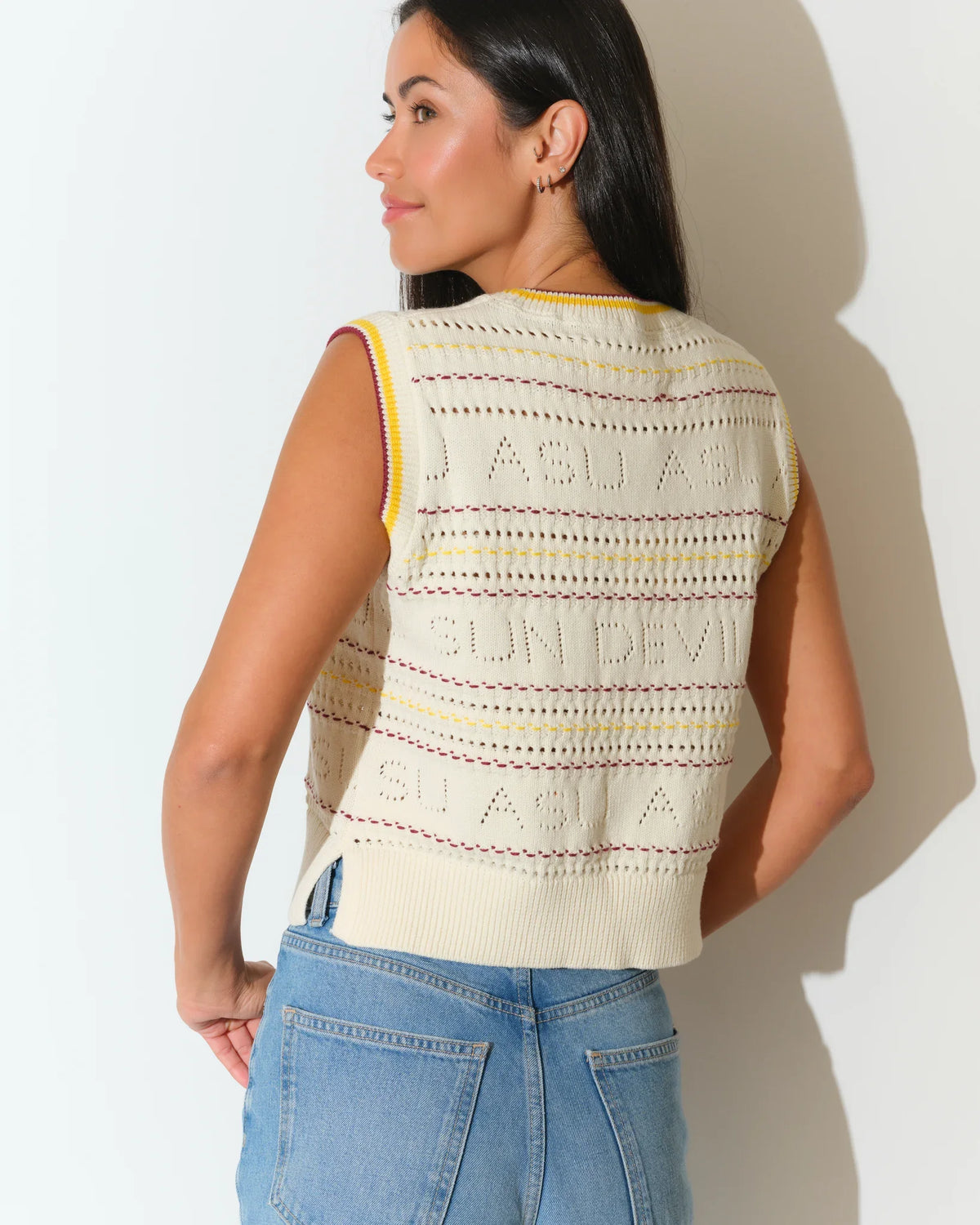 Ivory Arizona State Sun Devils sweater vest with colorful striped knit detailing, styled with light wash jeans.