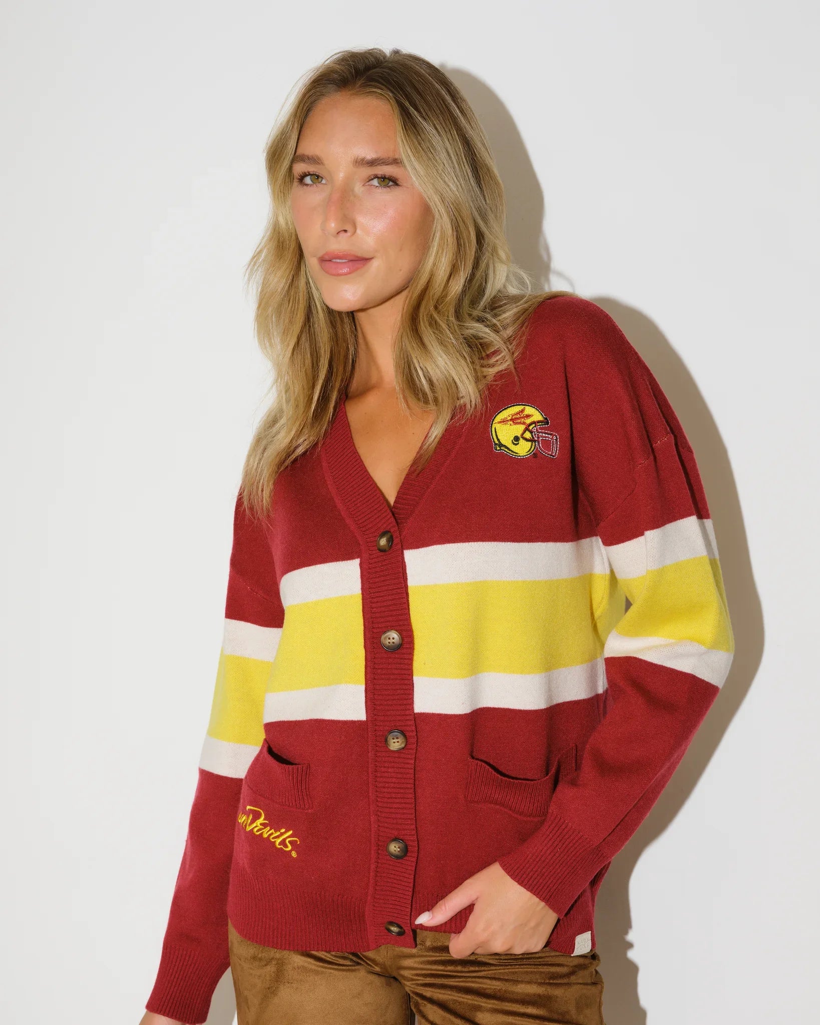 Black Arizona State Sun Devils cardigan with gold and white chest stripes, embroidered logo patch, button front, and front pockets.