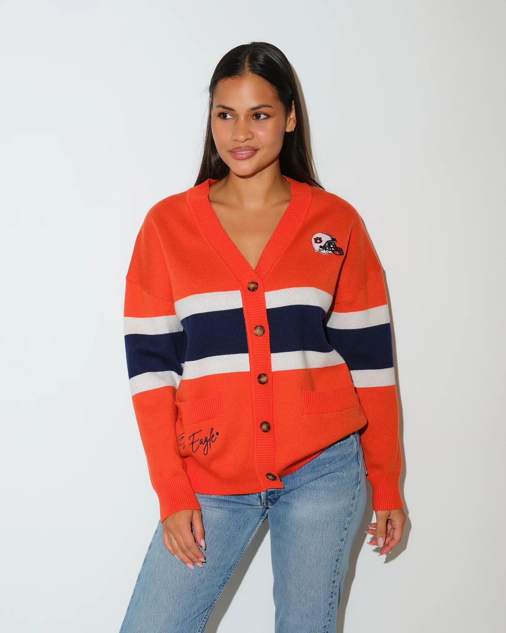 Orange Auburn Tigers Vinti cardigan with navy and white chest stripes, button front, and embroidered logo patch, styled with jeans.