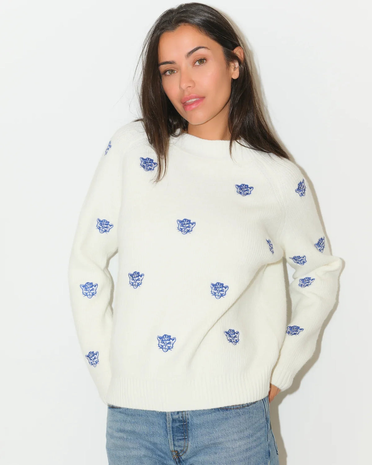 Ivory BYU Cougars fisherman sweater with allover embroidered blue Cougar head logos, featuring a relaxed fit and ribbed hem.