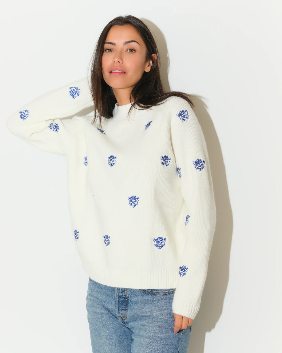 Ivory BYU Cougars fisherman sweater with allover embroidered blue Cougar head logos, featuring a relaxed fit and ribbed hem.