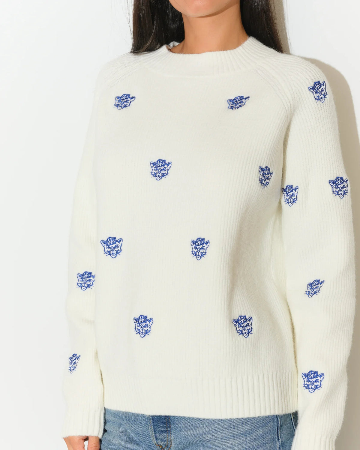Ivory BYU Cougars fisherman sweater with allover embroidered blue Cougar head logos, featuring a relaxed fit and ribbed hem.