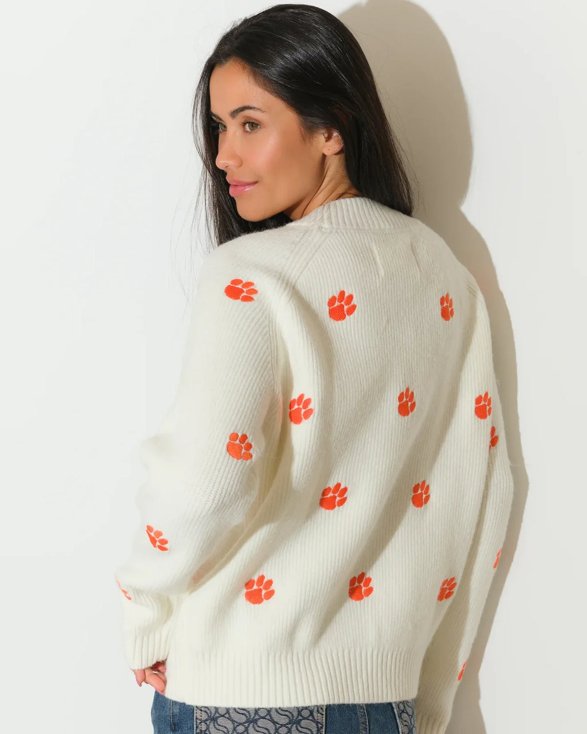 Ivory Clemson Tigers fisherman sweater featuring allover orange tiger paw embroidery, shown in a relaxed fit with a crew neckline.