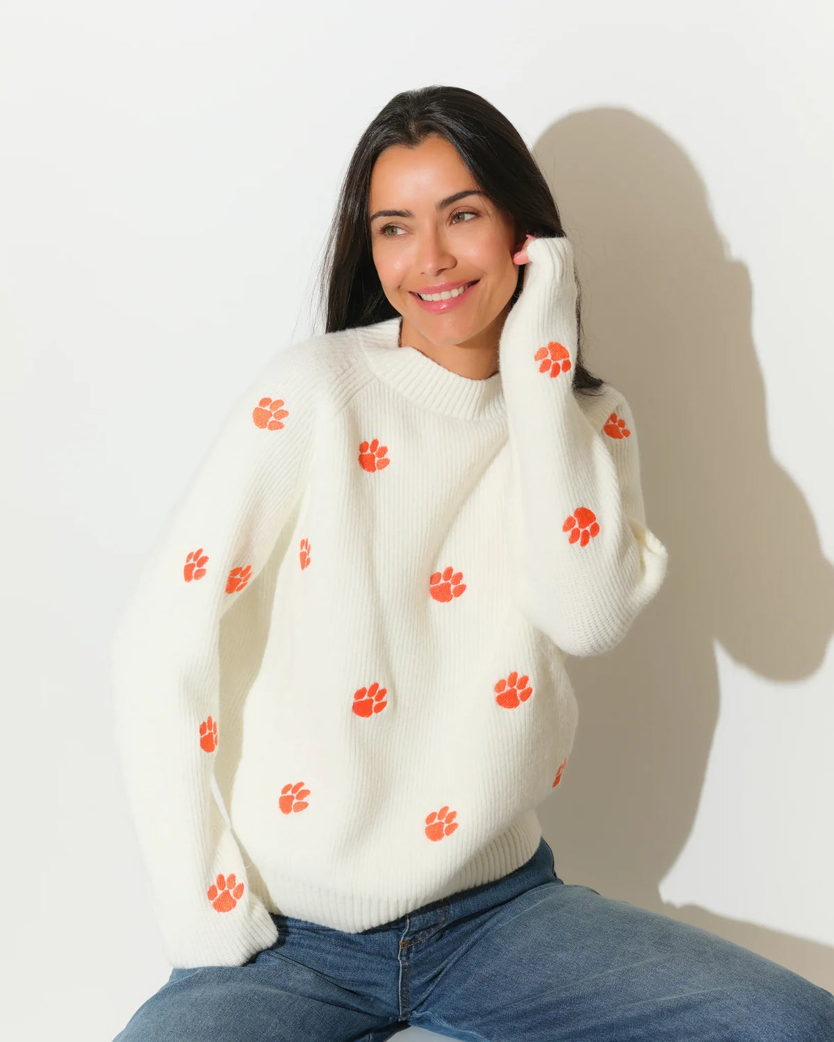 Ivory Clemson Tigers fisherman sweater featuring allover orange tiger paw embroidery, shown in a relaxed fit with a crew neckline.