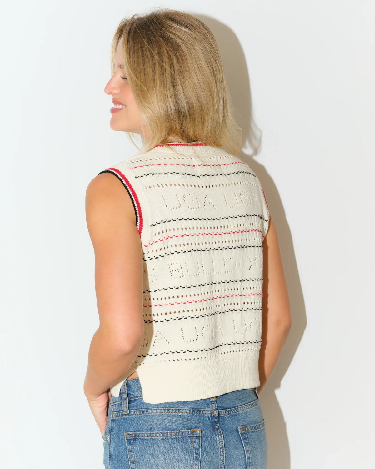 Ivory Georgia Bulldogs cropped sweater vest with open-knit texture, embroidered UGA lettering, and red-striped ribbed neckline and armholes.