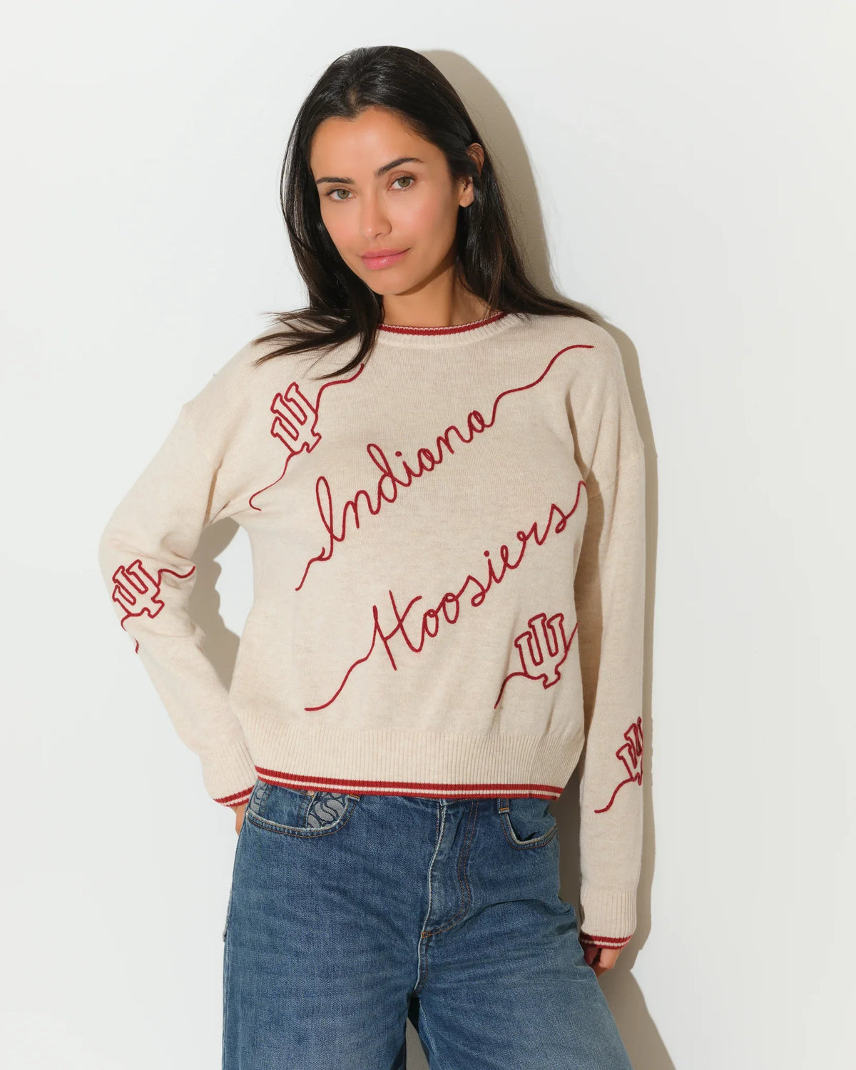 Crimson Indiana Hoosiers oversized knit sweater with white script "Indiana Hoosiers" lettering across the front, styled with white pants.