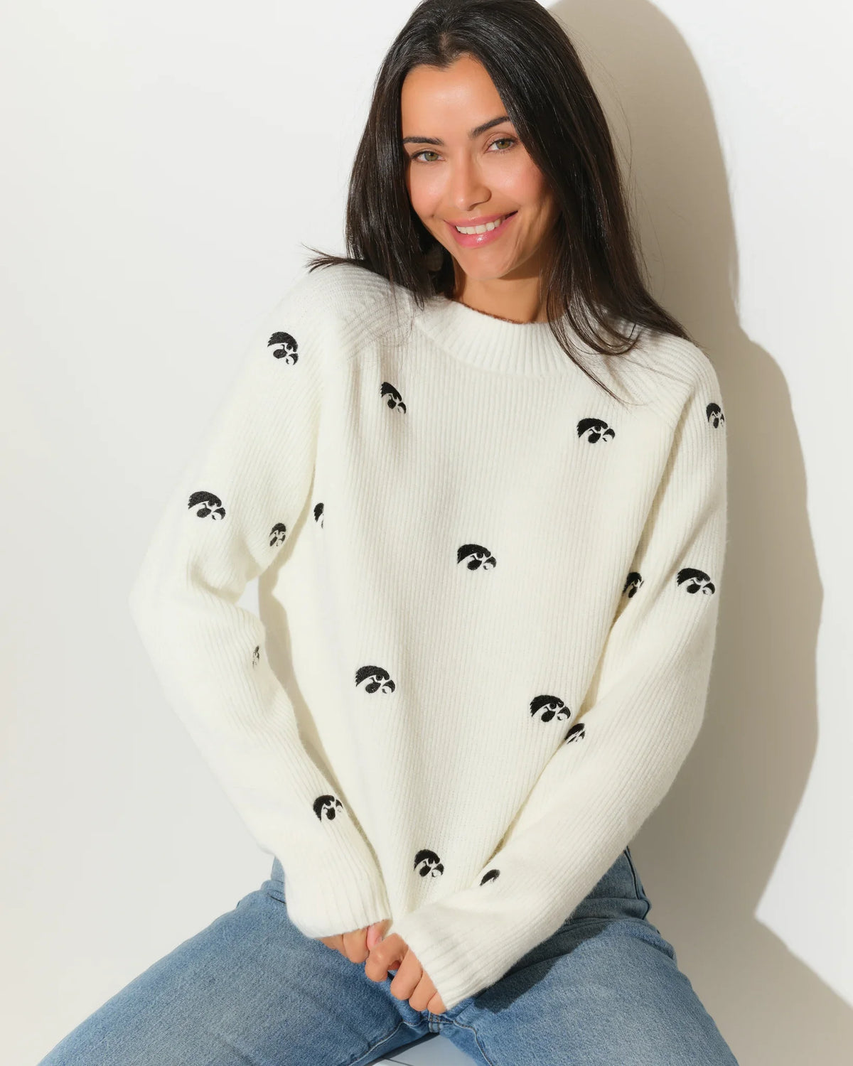 Ivory Iowa Hawkeyes fisherman sweater with allover embroidered Tigerhawk logos, shown in a relaxed crewneck knit style.