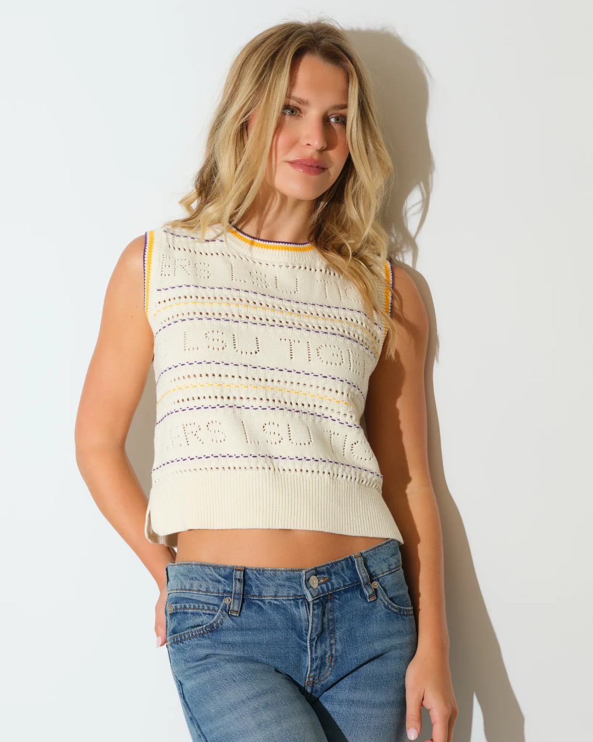 Ivory knit sweater vest for LSU Tigers fans, featuring embroidered team lettering and a striped crew neckline.