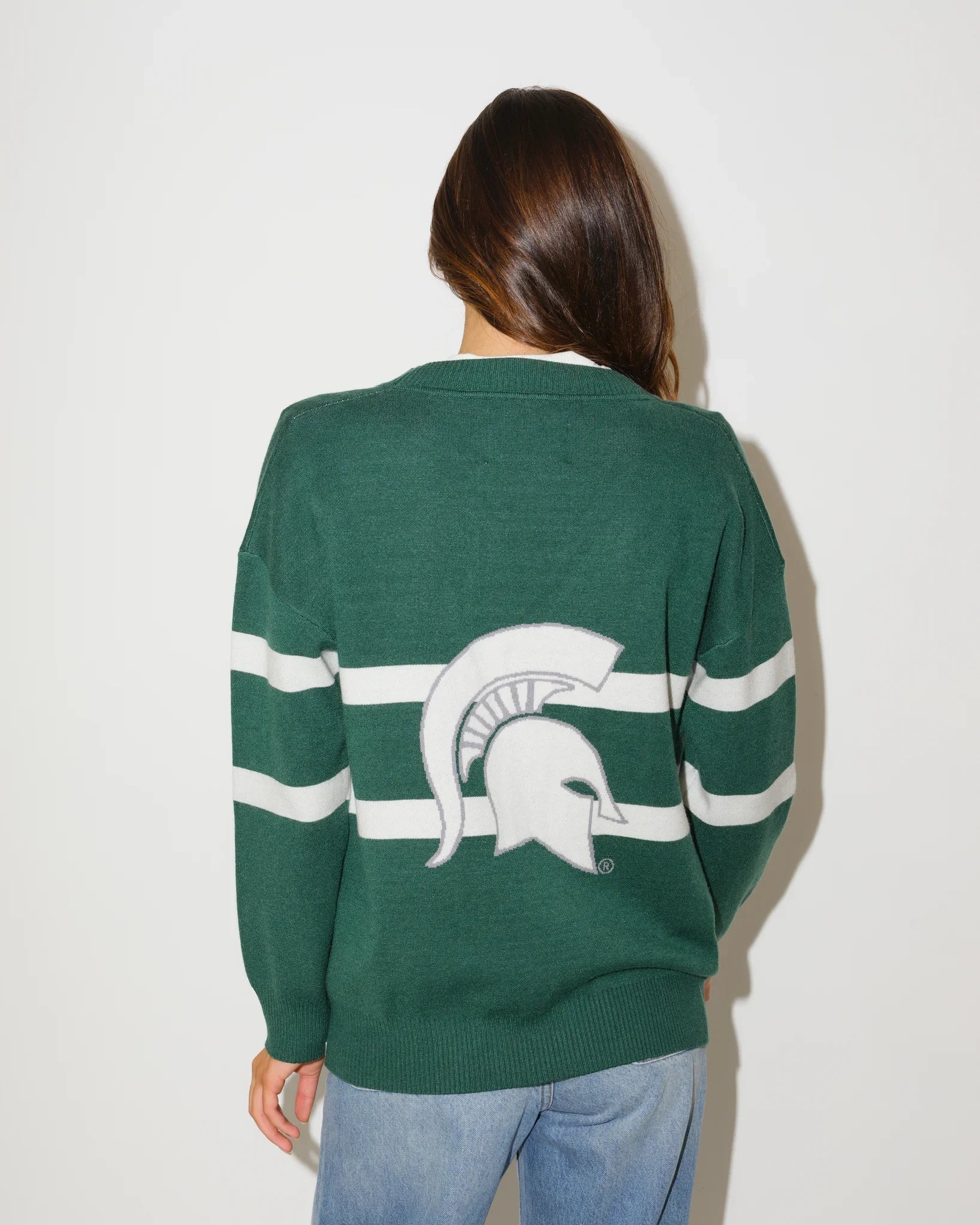 Evergreen Michigan State Spartans Vinti Cardi in a relaxed fit with script graphics and floral sleeve details, styled with denim shorts and boots.