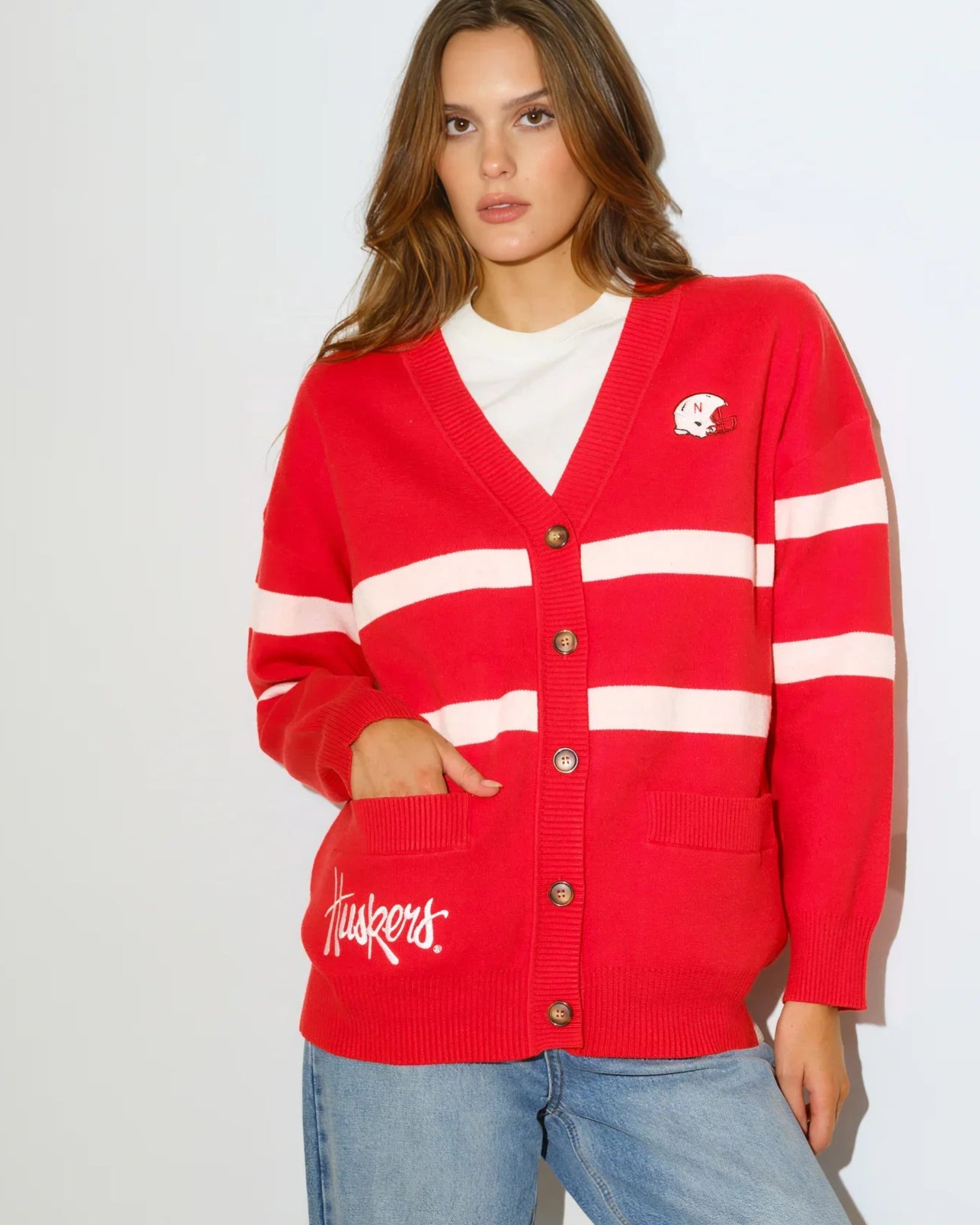 Red Nebraska Cornhuskers Vinti Cardi sweater with colorblock stripes and an embroidered vintage football helmet logo at the chest.