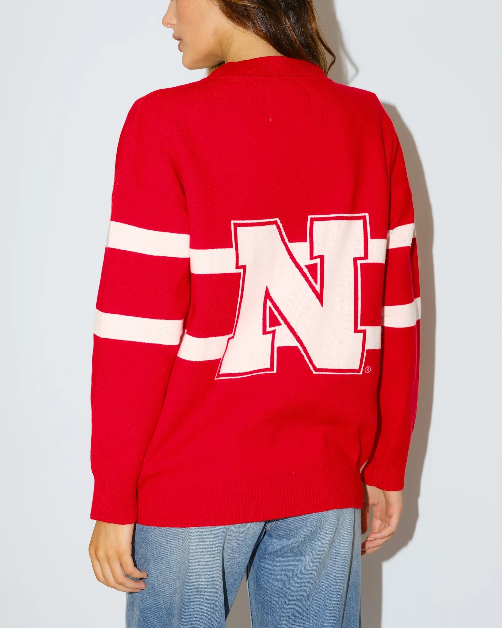 Red Nebraska Cornhuskers Vinti Cardi sweater with colorblock stripes and an embroidered vintage football helmet logo at the chest.