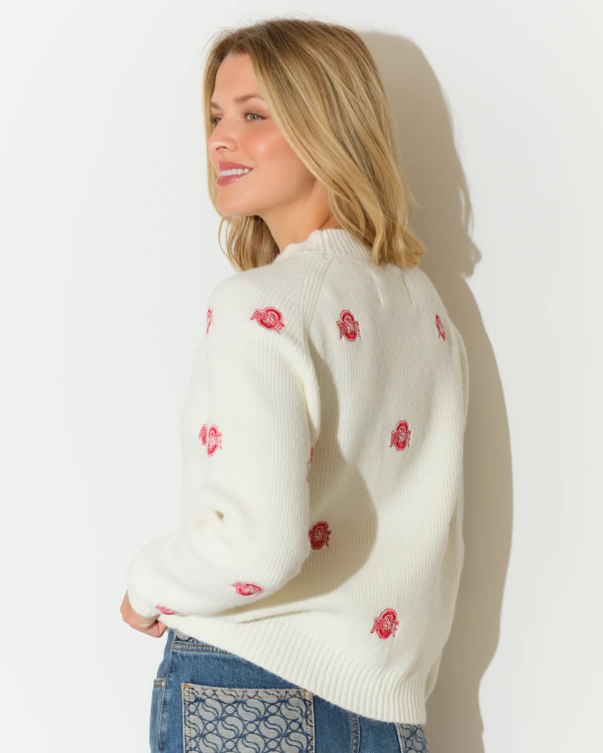 Ivory Ohio State Buckeyes fisherman sweater with scattered red Buckeye leaf embroidery, featuring a relaxed fit and ribbed cuffs.
