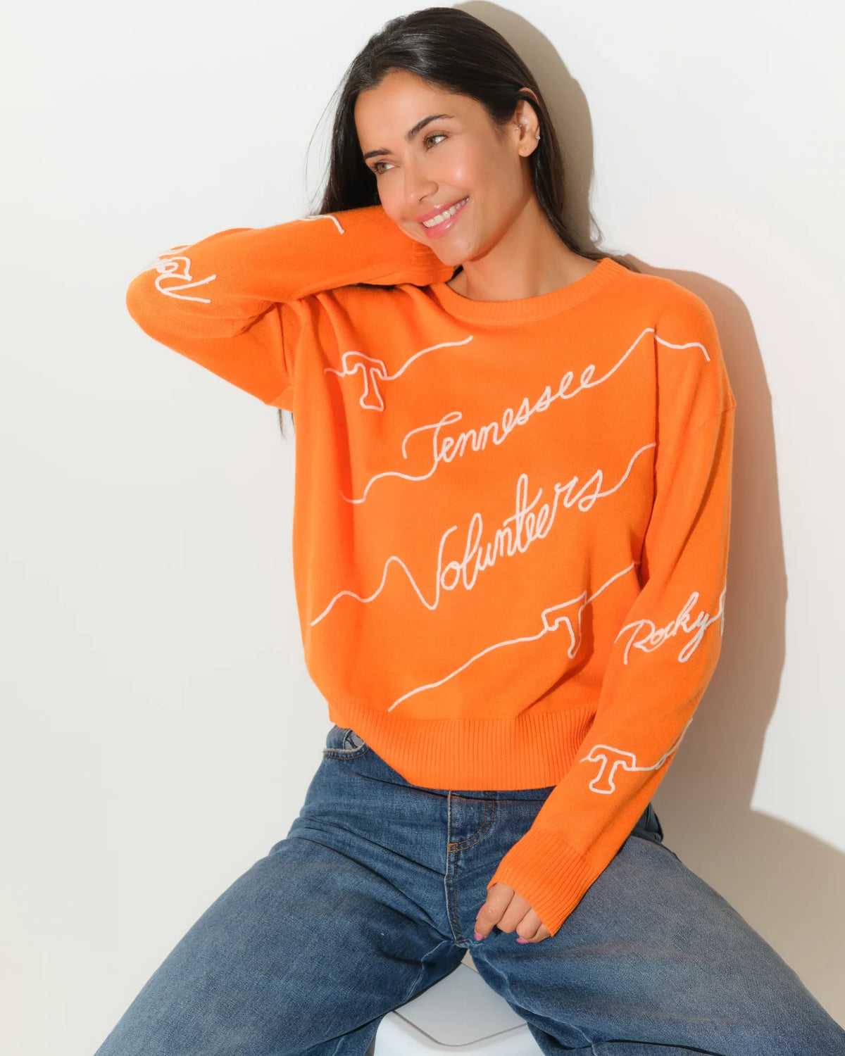Tennessee Orange Tennessee Volunteers crewneck sweater featuring repeated cursive "Tennessee Volunteers" script across the front and sleeves.