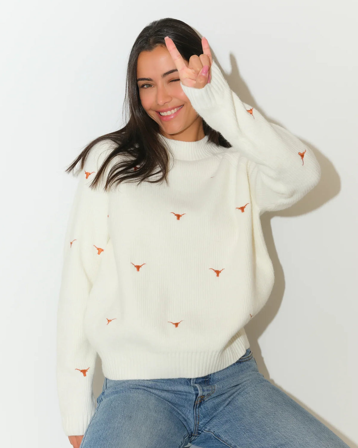 Ivory Texas Longhorns fisherman sweater featuring embroidered Longhorn logos, shown with a relaxed crew neck and ribbed cuffs.