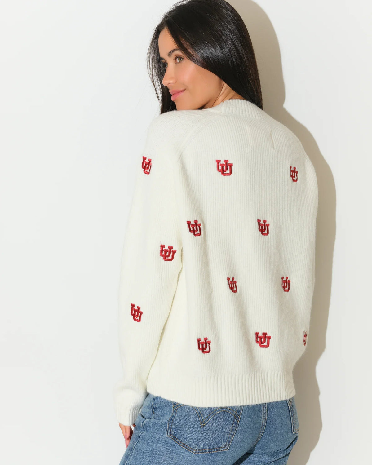 Ivory Utah Utes fisherman sweater with allover red embroidered UU logos, featuring a crew neck and ribbed cuffs.