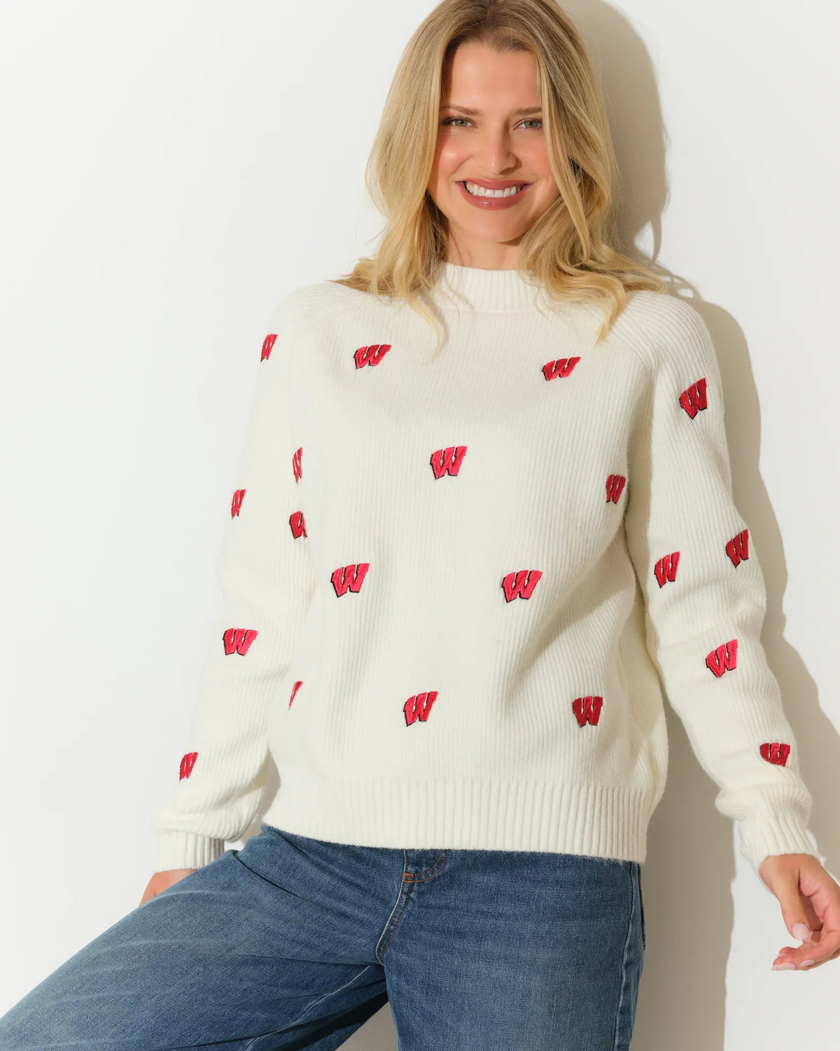 Ivory Wisconsin Badgers fisherman sweater with allover red Badger logo pattern, featuring a relaxed fit and ribbed cuffs.