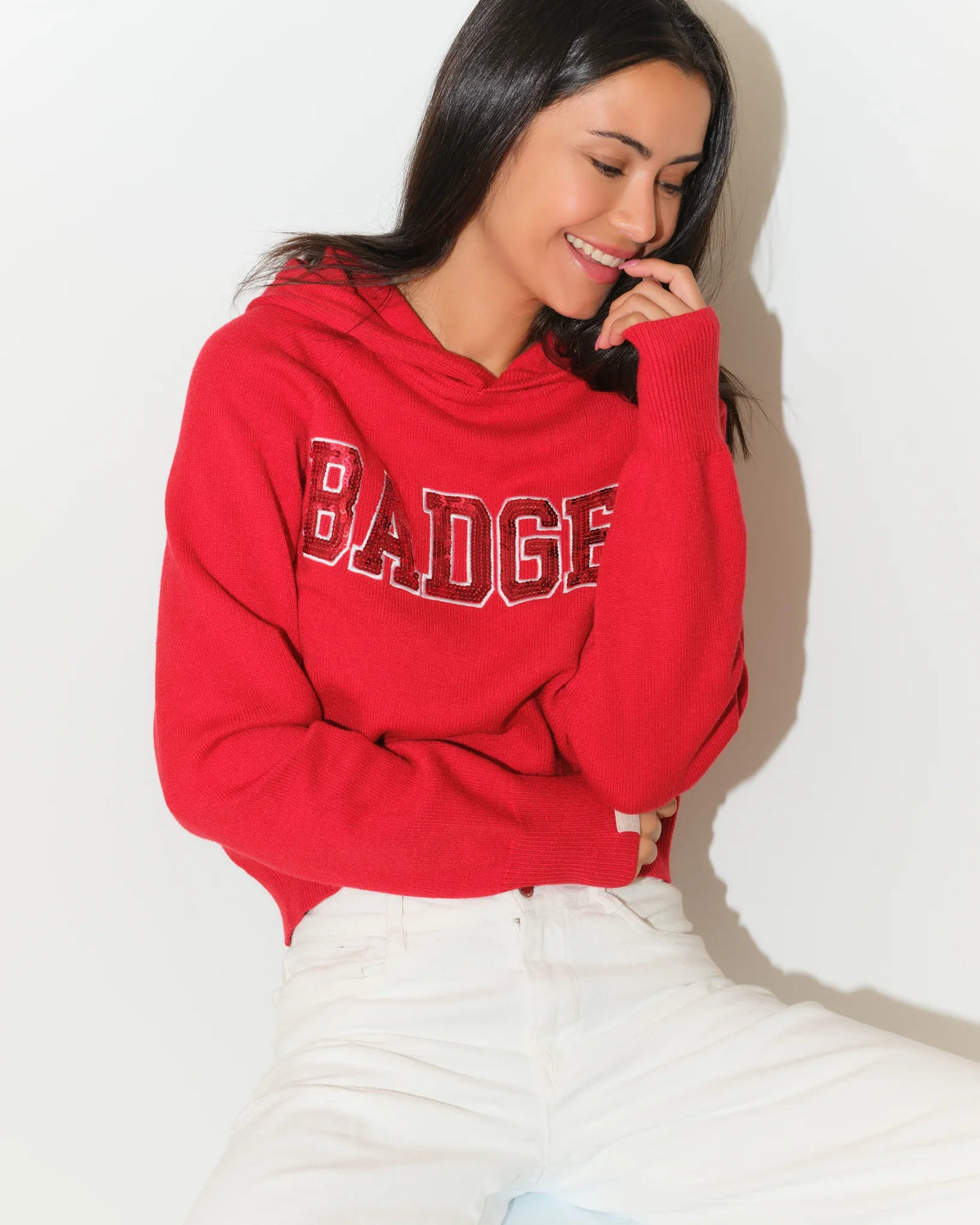 Red Wisconsin Badgers pullover hoodie with bold chenille "BADGERS" lettering across the chest, featuring a relaxed fit and front kangaroo pocket.