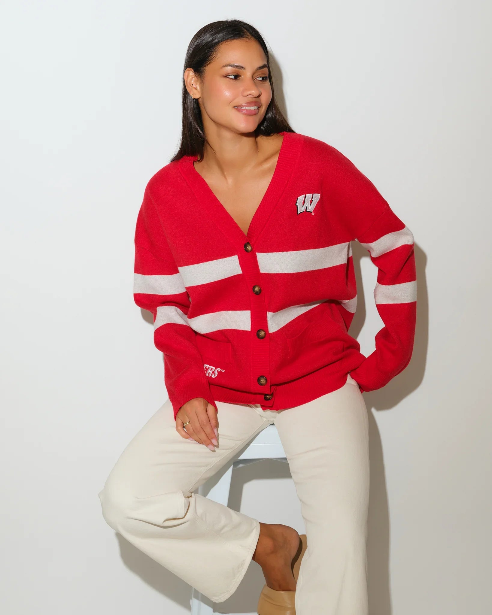 Red Wisconsin Badgers Vinti cardigan with white chest stripes, V-neck, button front, and embroidered "W" logo on the left chest.