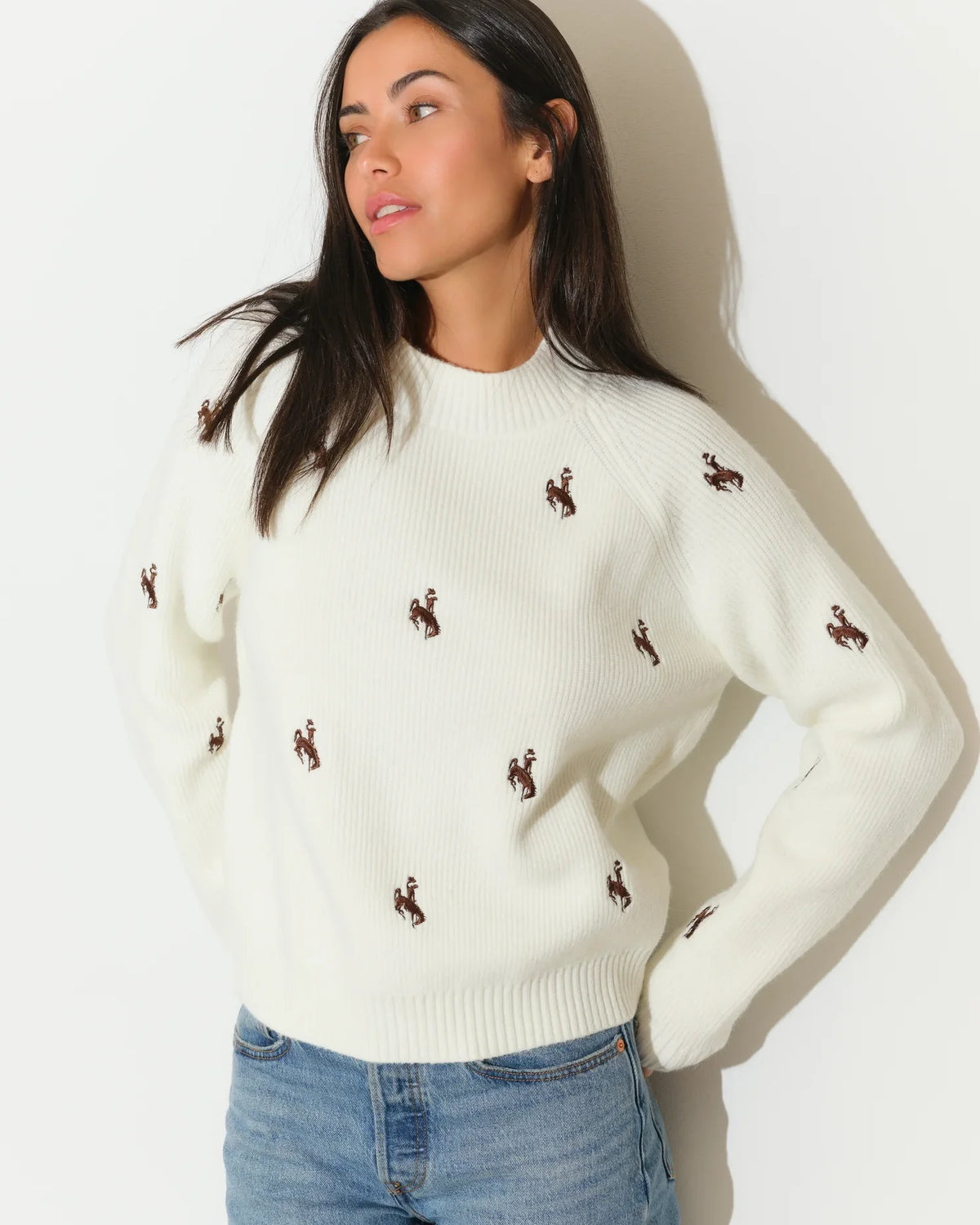 Ivory Wyoming Cowboys fisherman sweater with allover embroidered bucking horse logos, featuring a crew neck and relaxed fit.