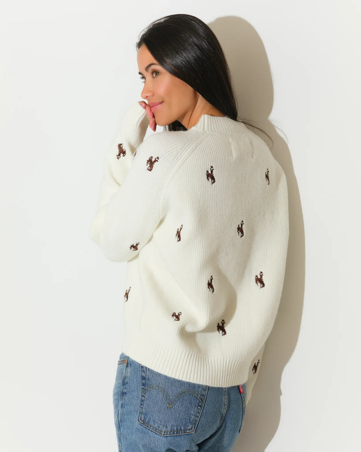 Ivory Wyoming Cowboys fisherman sweater with allover embroidered bucking horse logos, featuring a crew neck and relaxed fit.