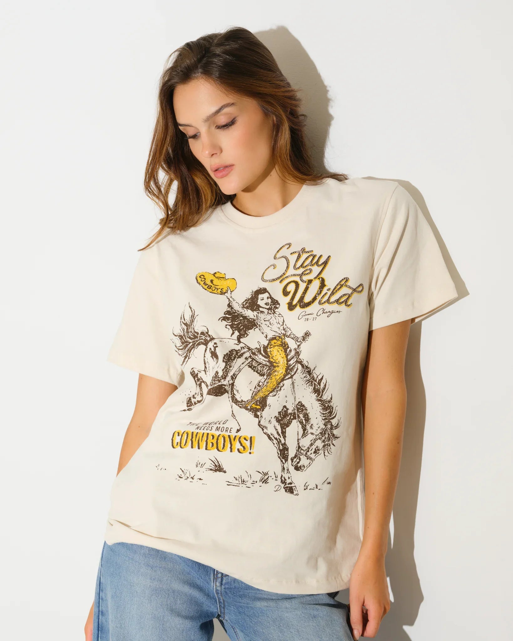 Bone Wyoming Cowboys Game Changer Tee with a vintage-style graphic of a rodeo rider and "Stay Wild" text, shown in a relaxed fit.