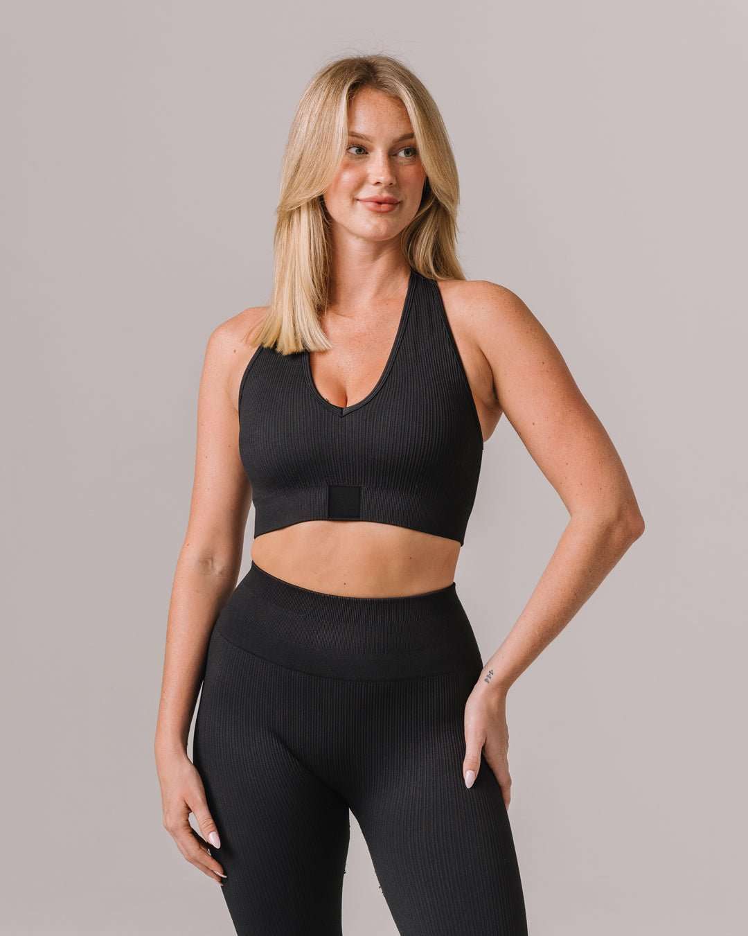 Black seamless sports bra with Colorado Buffaloes patch, styled for campus wear or workouts.