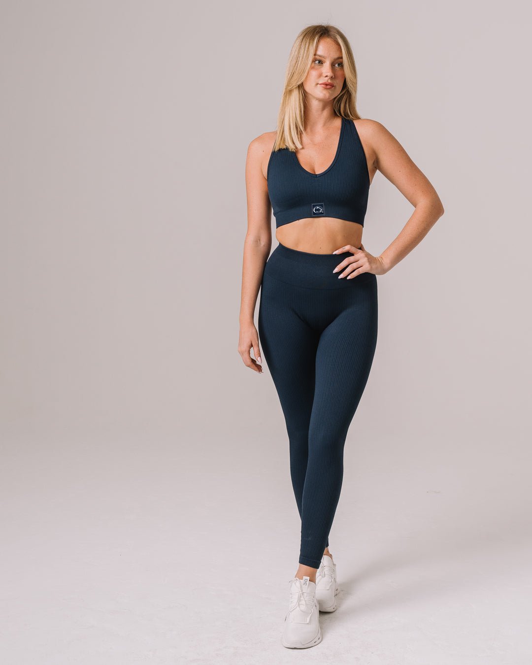 Navy seamless leggings with Penn State Nittany Lions logo, styled for game day or training.