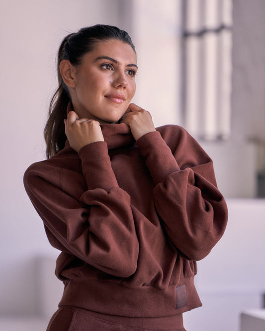 Front view of KADYLUXE® Corduroy Turtleneck Pullover in Root Beer