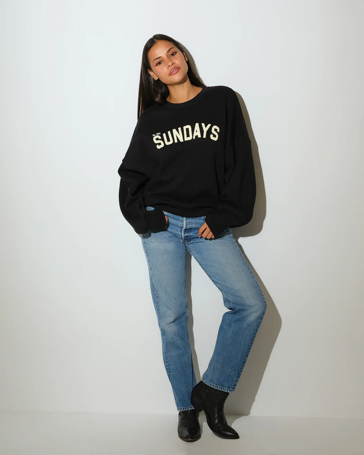 Black KadyLuxe balloon sleeve crew sweatshirt with cream "SUNDAYS" graphic lettering across the chest, featuring oversized dropped shoulders.