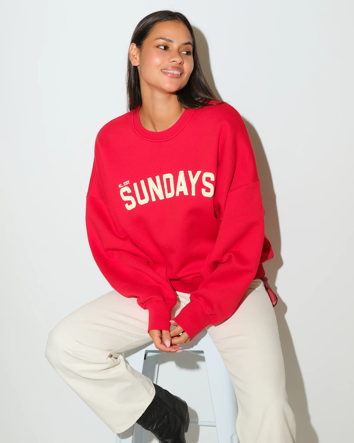 Red KadyLuxe Balloon Sleeve Crew sweatshirt with "SUNDAYS" graphic lettering across the chest, featuring a relaxed fit and crew neckline.