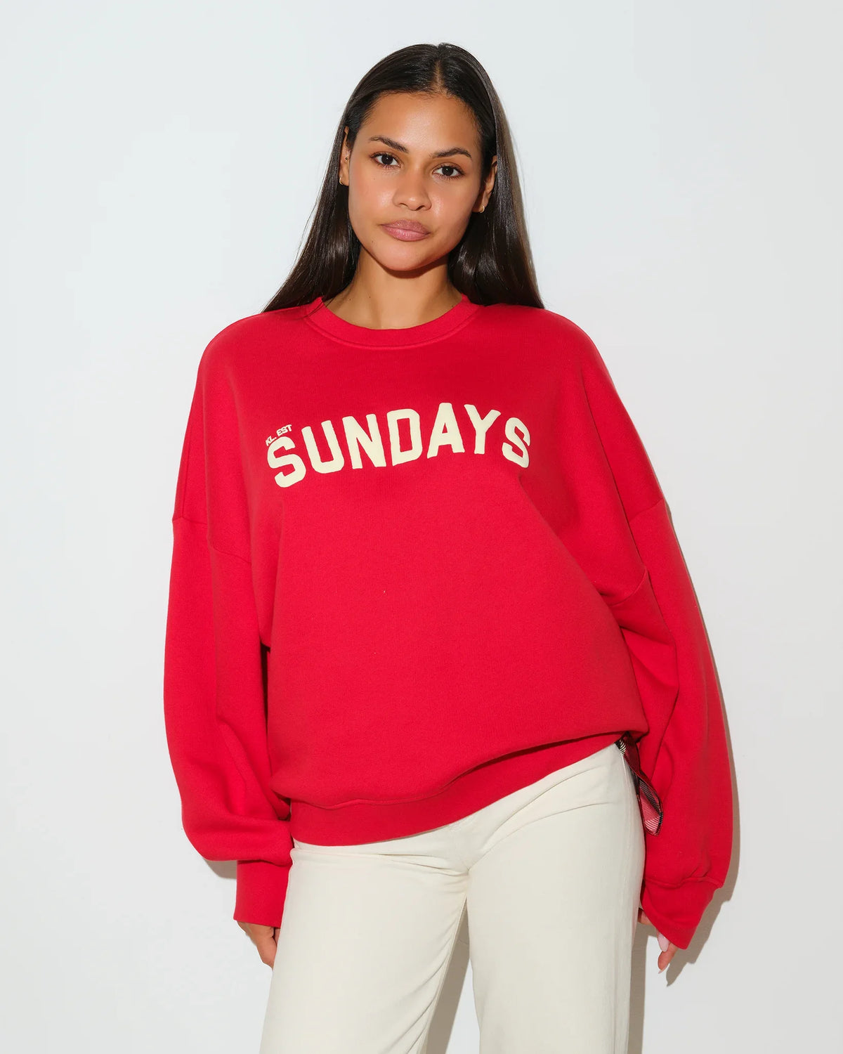 Red KadyLuxe Balloon Sleeve Crew sweatshirt with "SUNDAYS" graphic lettering across the chest, featuring a relaxed fit and crew neckline.