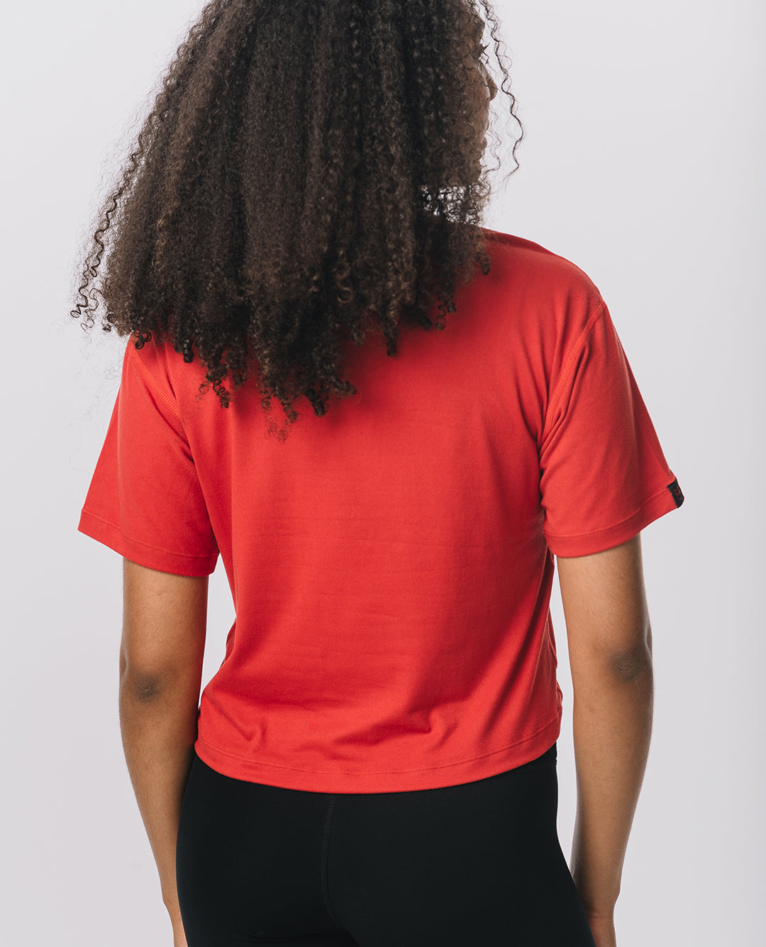 Back view of KADYLUXE® Milky Silk™ Crop Tee in Bold Red