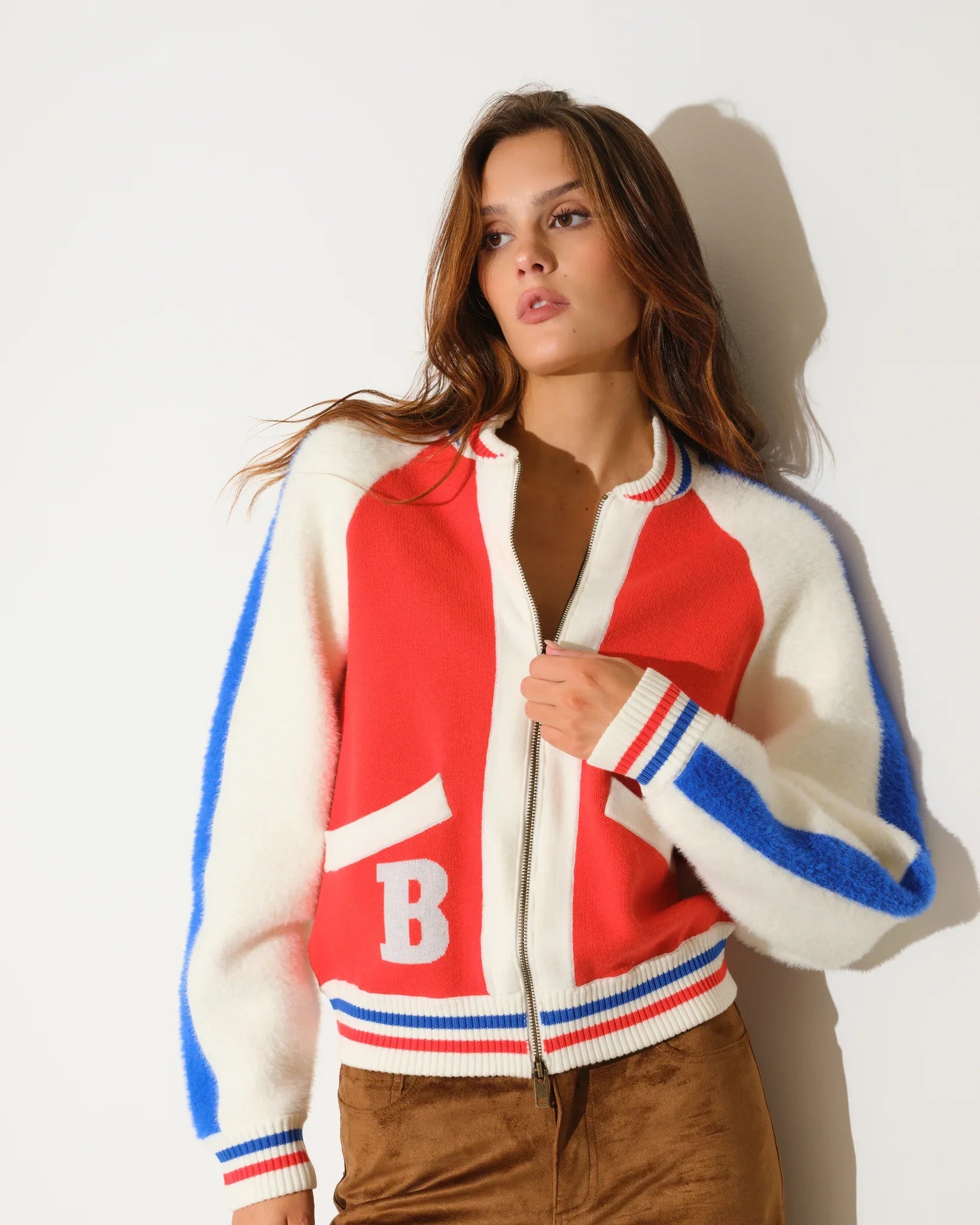 Orange Denver Broncos faux fur knit bomber jacket with red and blue colorblock panels, stripe trim, and a large "B" logo on the chest.