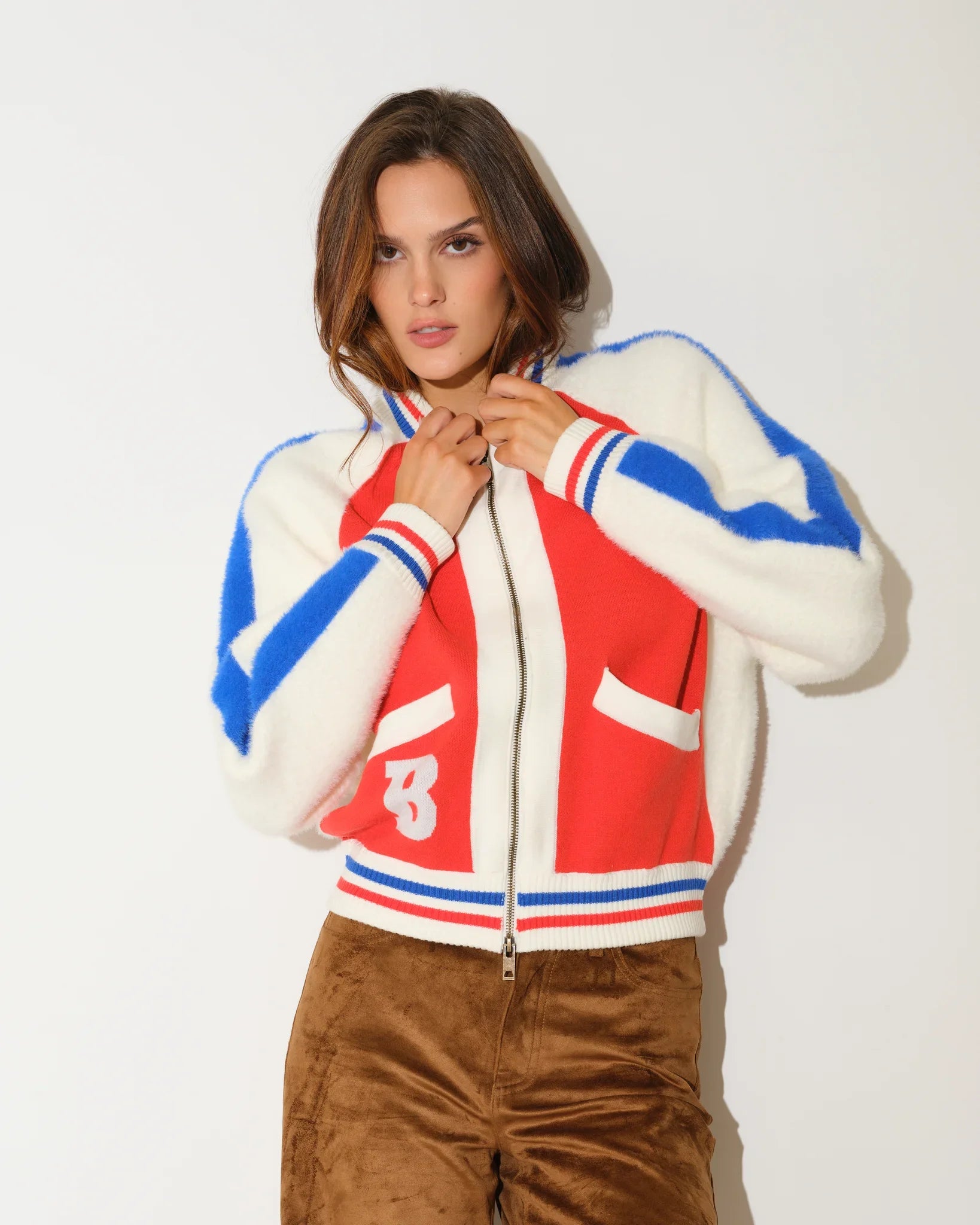 Orange Denver Broncos faux fur knit bomber jacket with red and blue colorblock panels, stripe trim, and a large "B" logo on the chest.