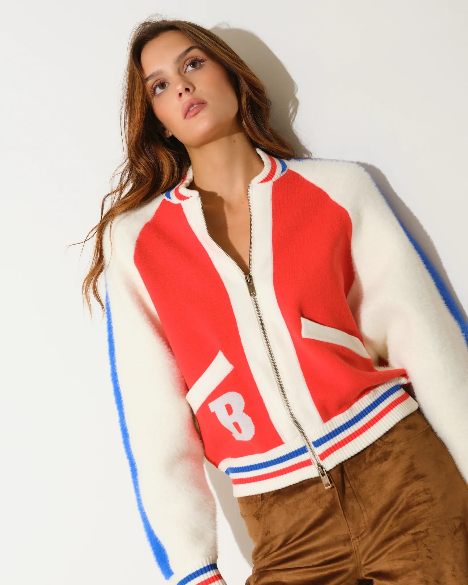 Orange Denver Broncos faux fur knit bomber jacket with red and blue colorblock panels, stripe trim, and a large "B" logo on the chest.