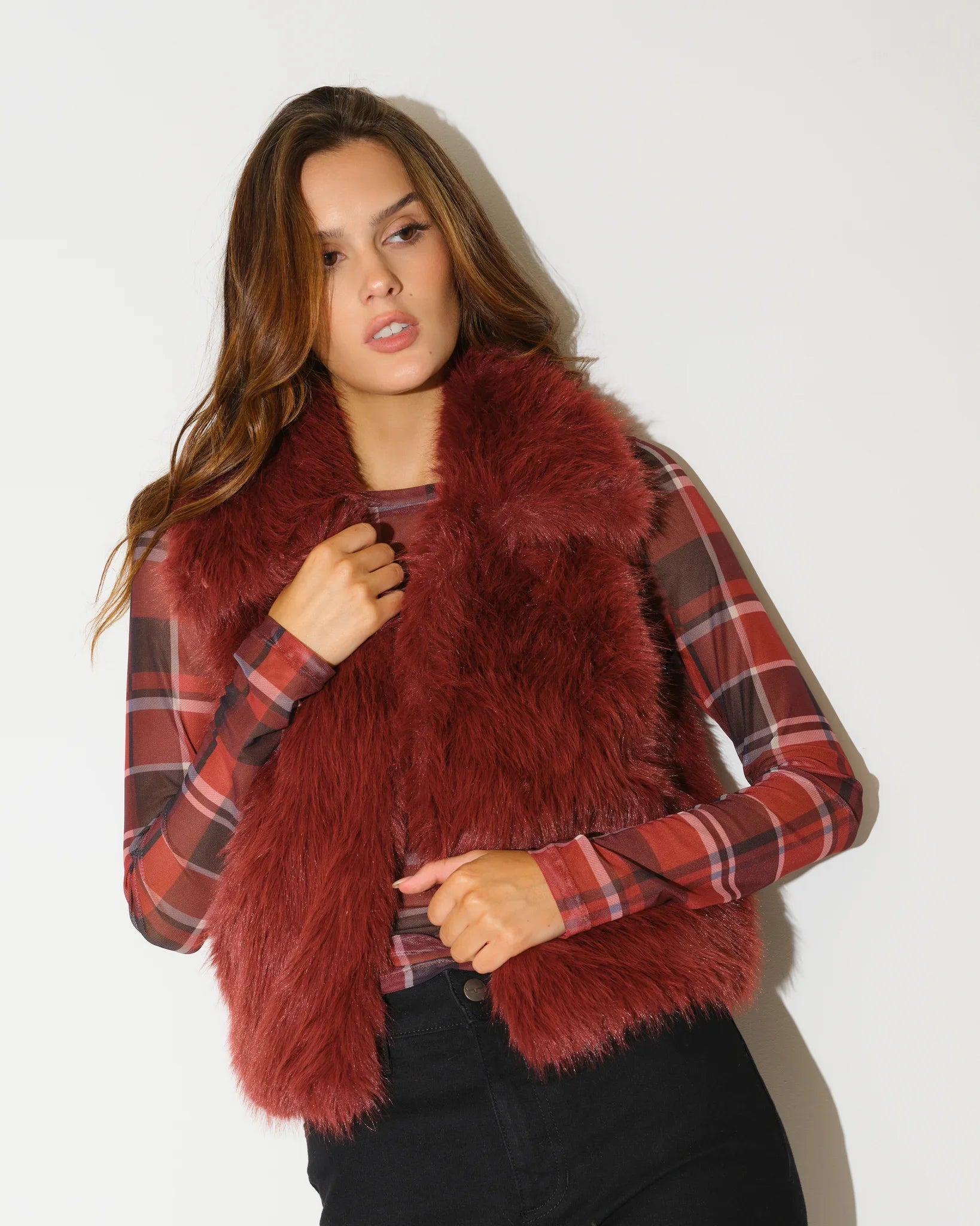 Oxblood reversible faux fur vest by KADYLUXE, shown with plush texture on the fur side and a sleeveless silhouette.