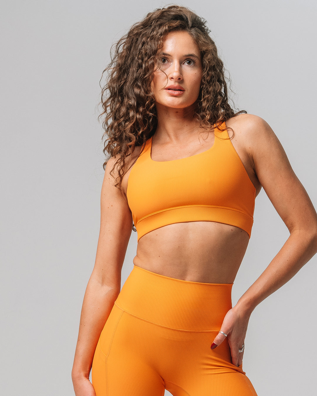 Front view of KADYLUXE® Rib Solstice Bra in Electric Mandarin