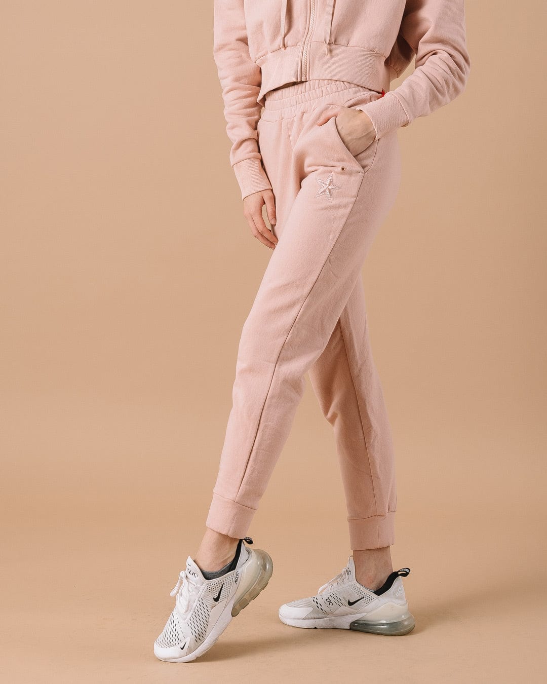 Pink sweatpants with Dallas Cowboys star patch, perfect for tailgates and lounging.