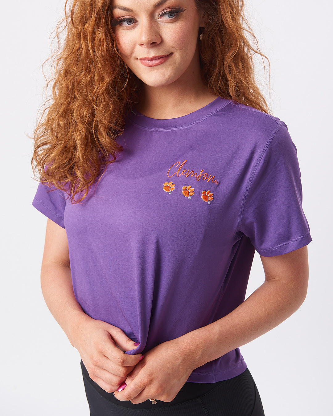 KADYLUXE® Clemson Tigers womens crop tee in color purple with Clemson and 3 paws embroidery on the left chest.