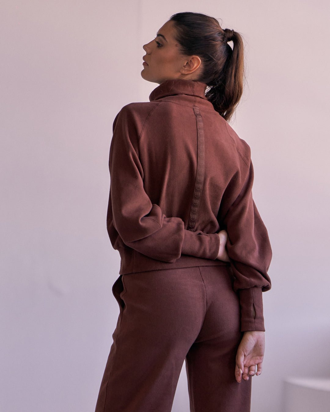 Back view of KADYLUXE® Corduroy Turtleneck Pullover in Root Beer