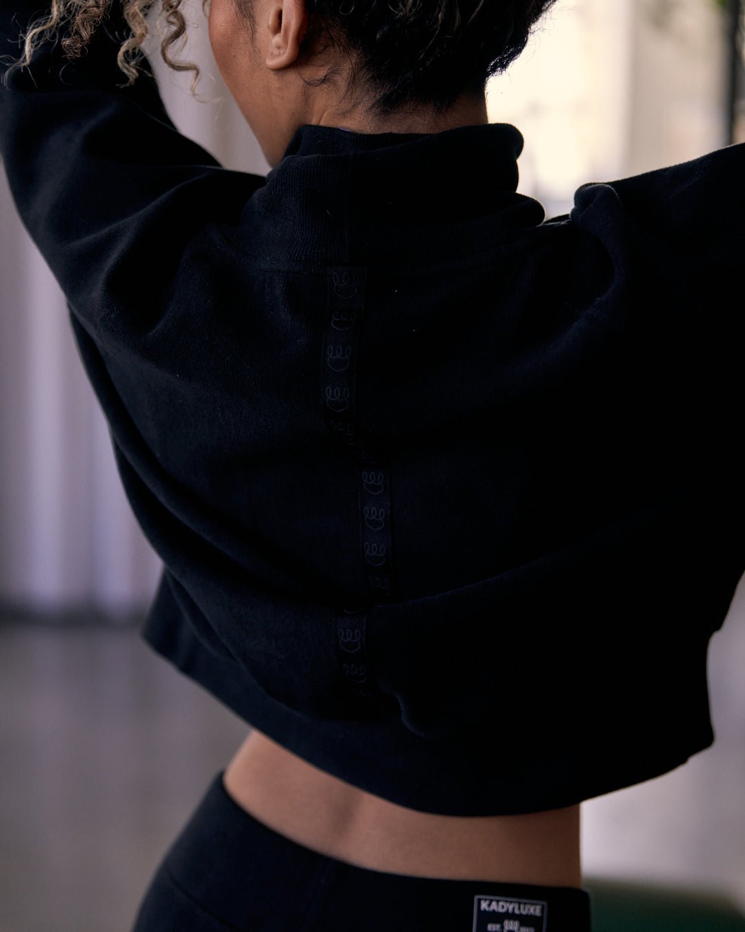 Back view of KADYLUXE® Corduroy Turtleneck Pullover in Black