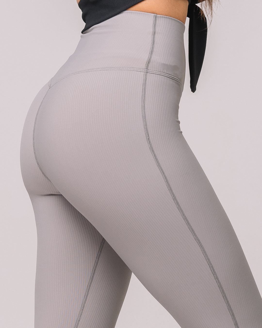 Side closeup view of KADYLUXE® Regal Rib Flare Pant in Cement Rib