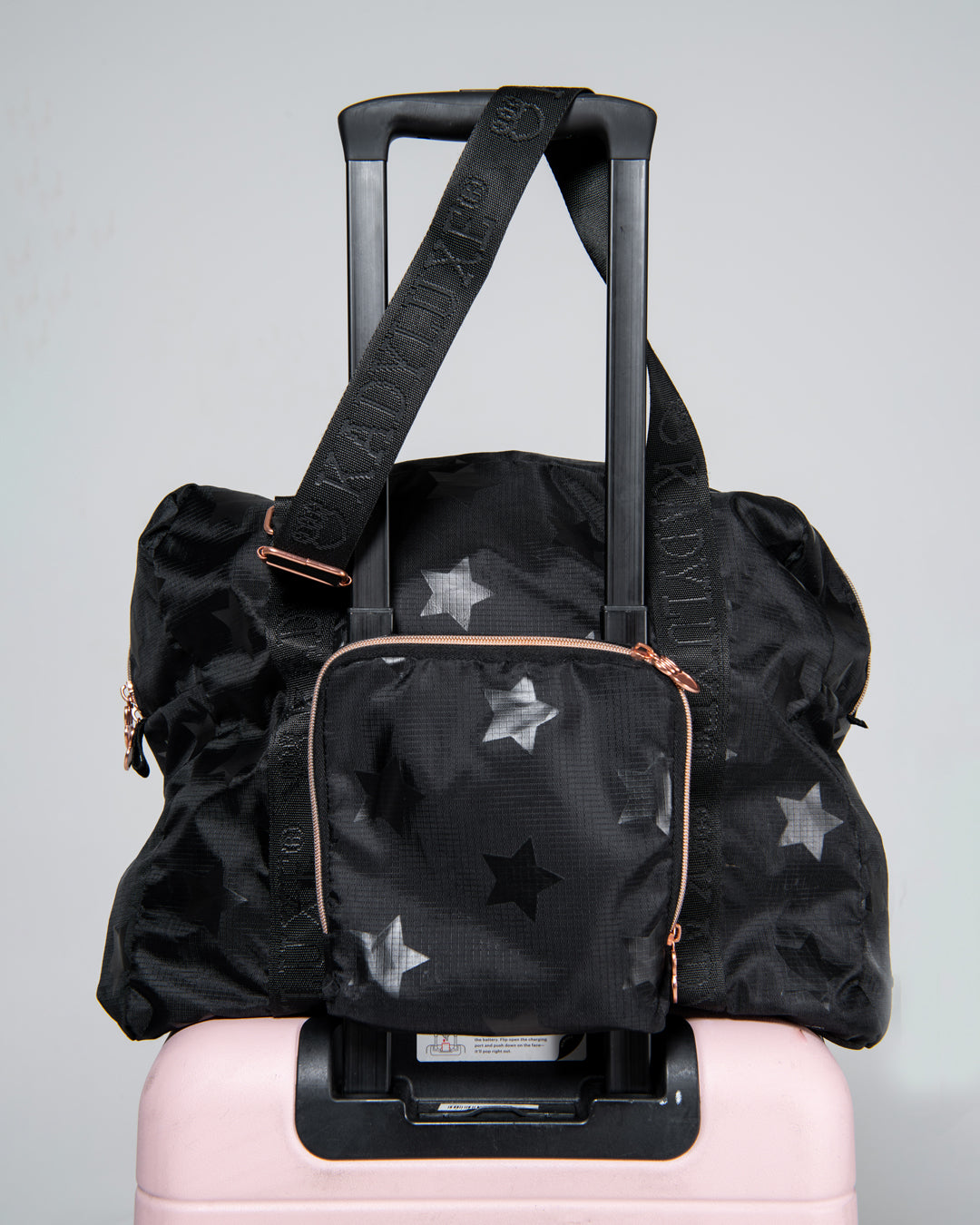KADYLUXE® packable travel bag in black star print close up view.
