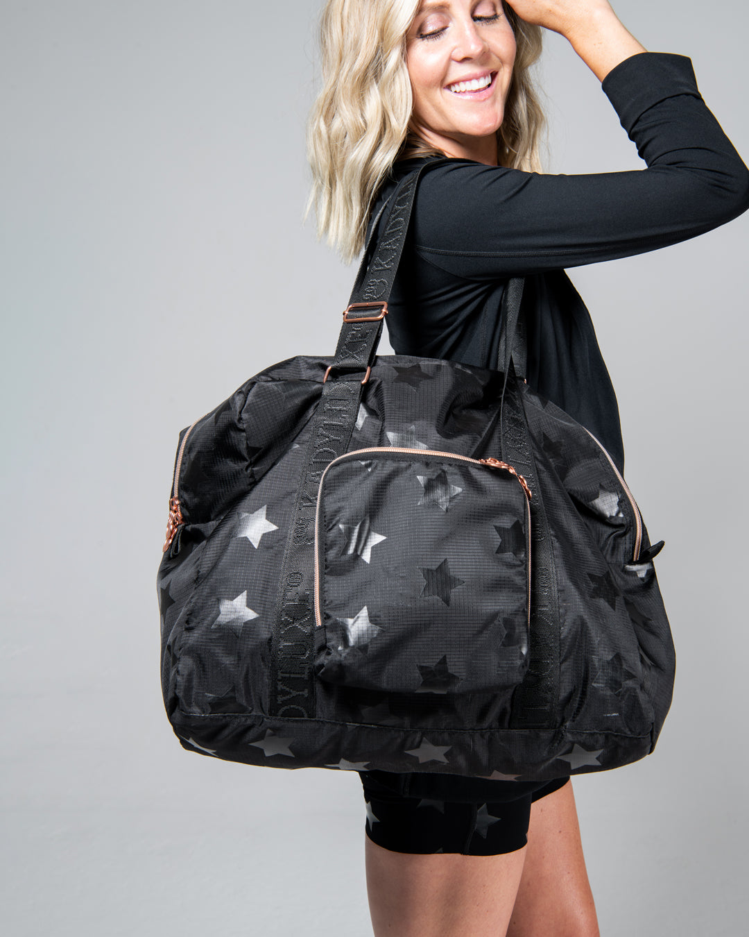 KADYLUXE® packable travel bag in black star print.